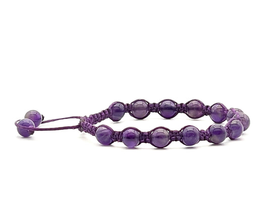 A macrame bracelet made with 6mm amethyst beads, crafted from purple cotton waxed cord, adjustable from 17cm to 22cm, suitable for women.